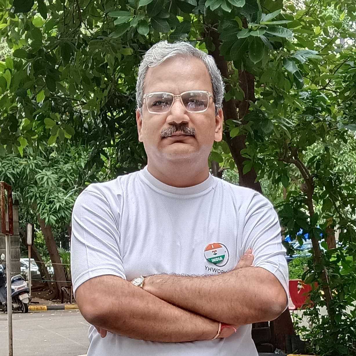 Dinesh Gajjar smiling in a green plain t-shirt